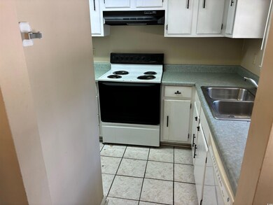 Kitchen featuring light tile patterned floors, sin