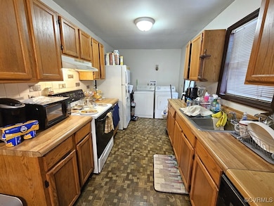 Kitchen featuring under cabinet range hood, black