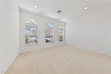 Empty room with recessed lighting, light carpet, a