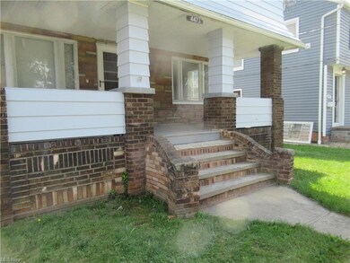 View of exterior entry with a yard