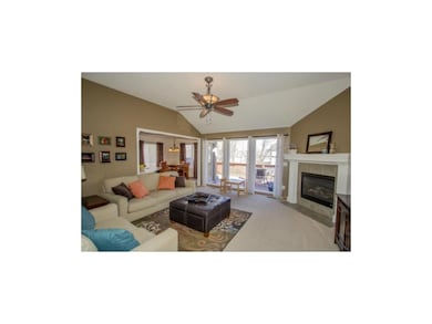 Large open living room with high ceiling looks out