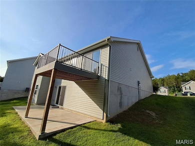 Rear view of house with a patio and a yard