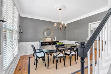 Dining space featuring stairway, ornamental moldin