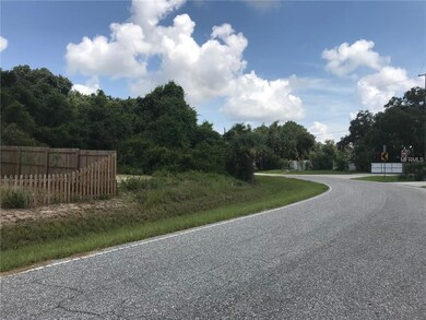 VIEW DOWN ROAD.  LOT IS THE FENCED ONE ON THE RIGH