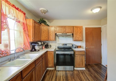 Kitchen featuring sink, stainless steel range with