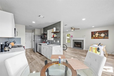Dining area with a tiled fireplace, visible vents