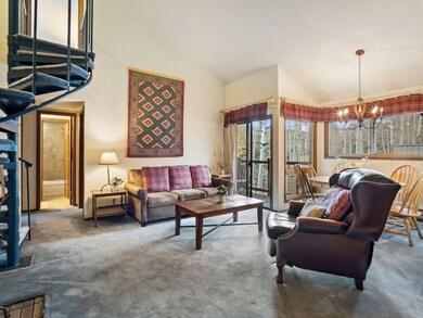 Living room featuring high vaulted ceiling, carpet