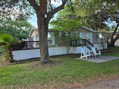 View of front facade with a front lawn, a patio, and a deck