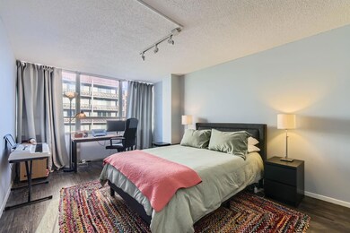 Bedroom featuring a textured ceiling, wood finish