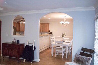 Dining and kitchen open to living room.