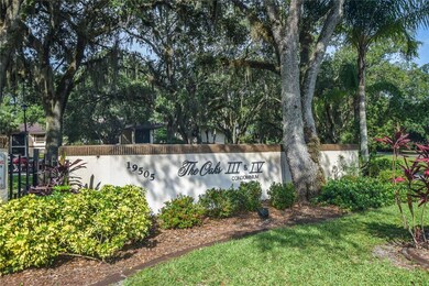The Oaks Entrance Sign and Large Oak Trees Welcome