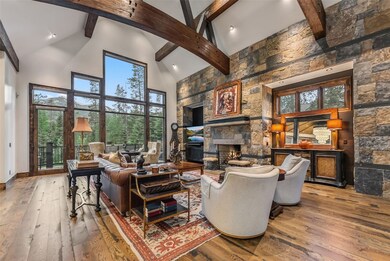 Living area featuring high vaulted ceiling, a fire