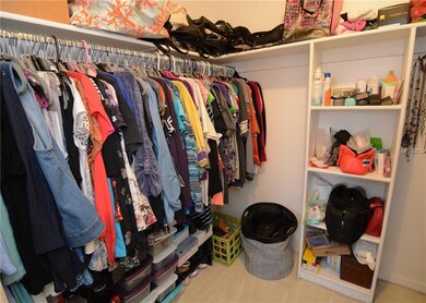 Walk-in closet in master bedroom.