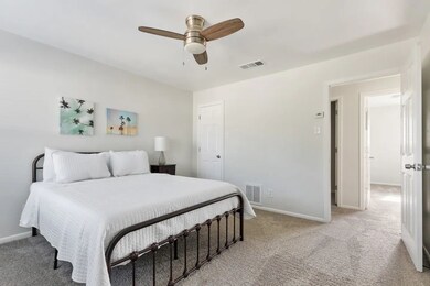 Bedroom with light carpet and ceiling fan