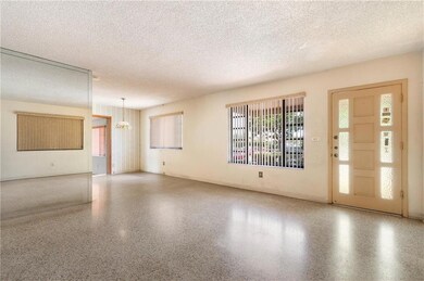 Another view of living room, entrance, and dining