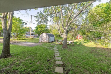 View of yard with fence, an outdoor structure, and