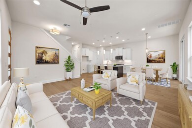 Living room with recessed lighting, stairs, visib