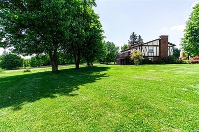 View of end of home and deck along the back of the