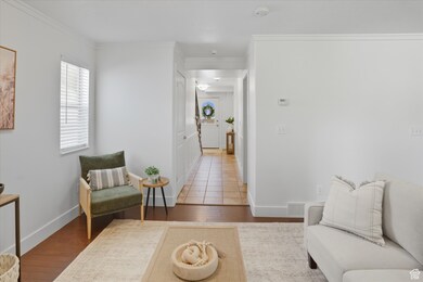 Sitting room featuring wood finished floors and ornamental molding