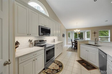 Updated kitchen with solid surface counters and walk-in pantry.
