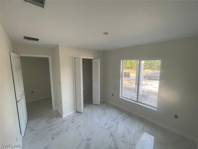 Unfurnished bedroom with light tile flooring