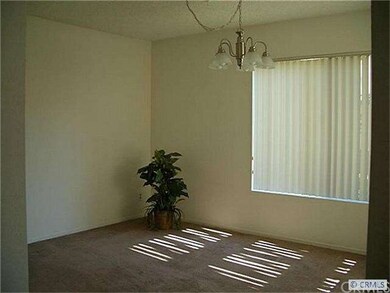 Sunny formal dining room with view to greenbelt.