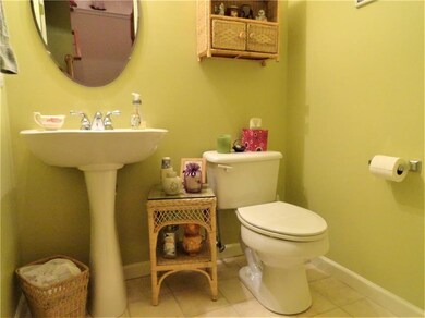 The main level powder room with pedestal sink sepa