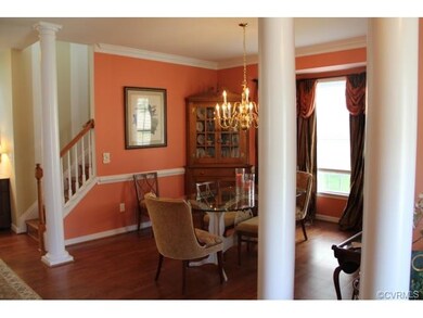 The dining room is accented with columns, hardwood