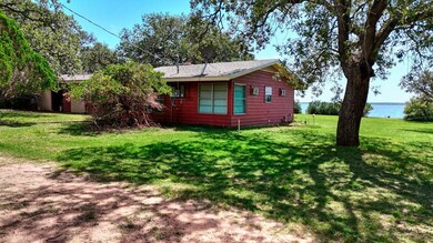 View of property exterior with a lawn and a water