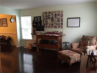 Formal living room with wood laminate flooring.