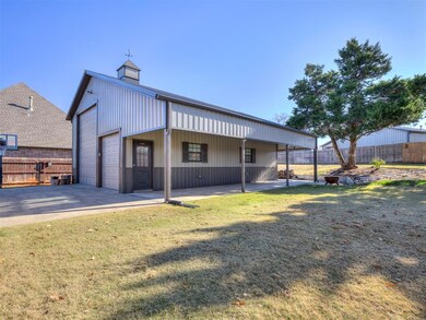 Rear view of property with a lawn, an outbuilding,