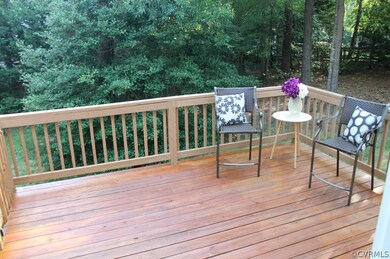 FRESHLY STAINED DECK IS NESTLED IN WOODED REAR YAR
