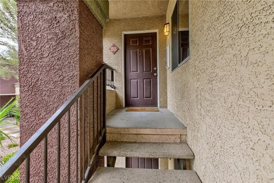 Entrance to property with stucco siding