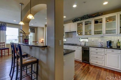 Open floor plan -- distressed wood floors in kitch