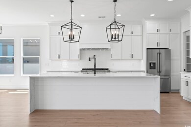 Kitchen featuring high end fridge, pendant lightin