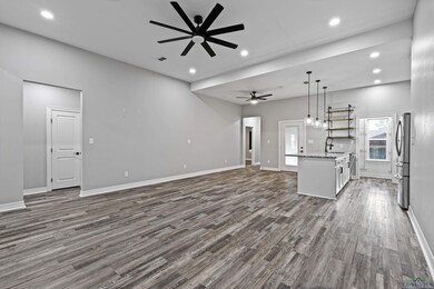 Unfurnished living room featuring dark hardwood / 