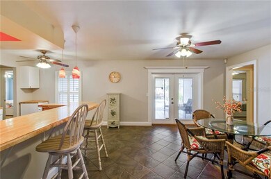 French doors lead to covered lanai and sparkling s