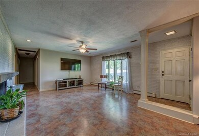 The spacious living room has large windows with lots of natural light