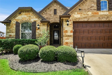 French provincial home with stone siding, brick s