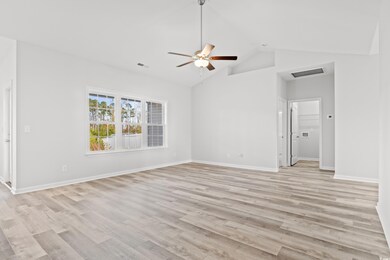 Spare room featuring ceiling fan, high vaulted cei