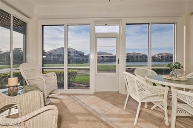 Sunroom / solarium featuring a water view