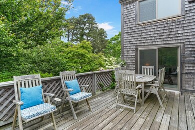 Intimate deck surrounded by mature flowering trees.