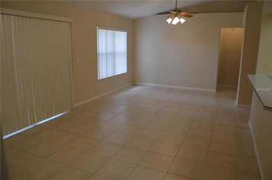 Living room / dining room view from master bedroom.  Room has 2 ceiling fans.  Hallway to secondary bedrooms is straight ahead.  Vaulted ceilings make this room feel even larger.