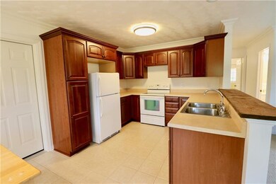 THE KITCHEN FEATURES PRETTY CHERRY CABINETRY AND P