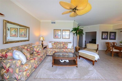 Living room with crown molding, light tile pattern