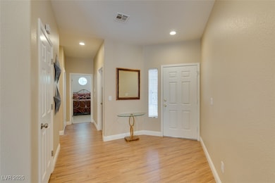 Entryway with light wood-style flooring and recess