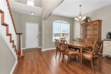 Dining room featuring stairs, dark wood-type floor