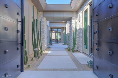 Custom iron double doors allow entry into a beauti