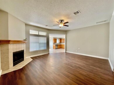 Unfurnished living room with a tile fireplace, cei