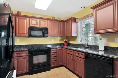 Kitchen with cherry cabinets and granite counters